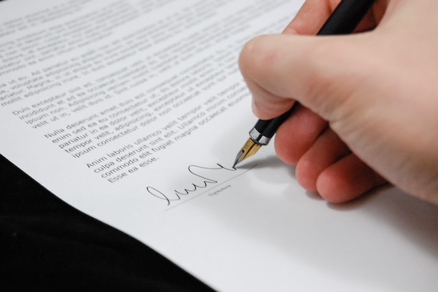 hand signing paper