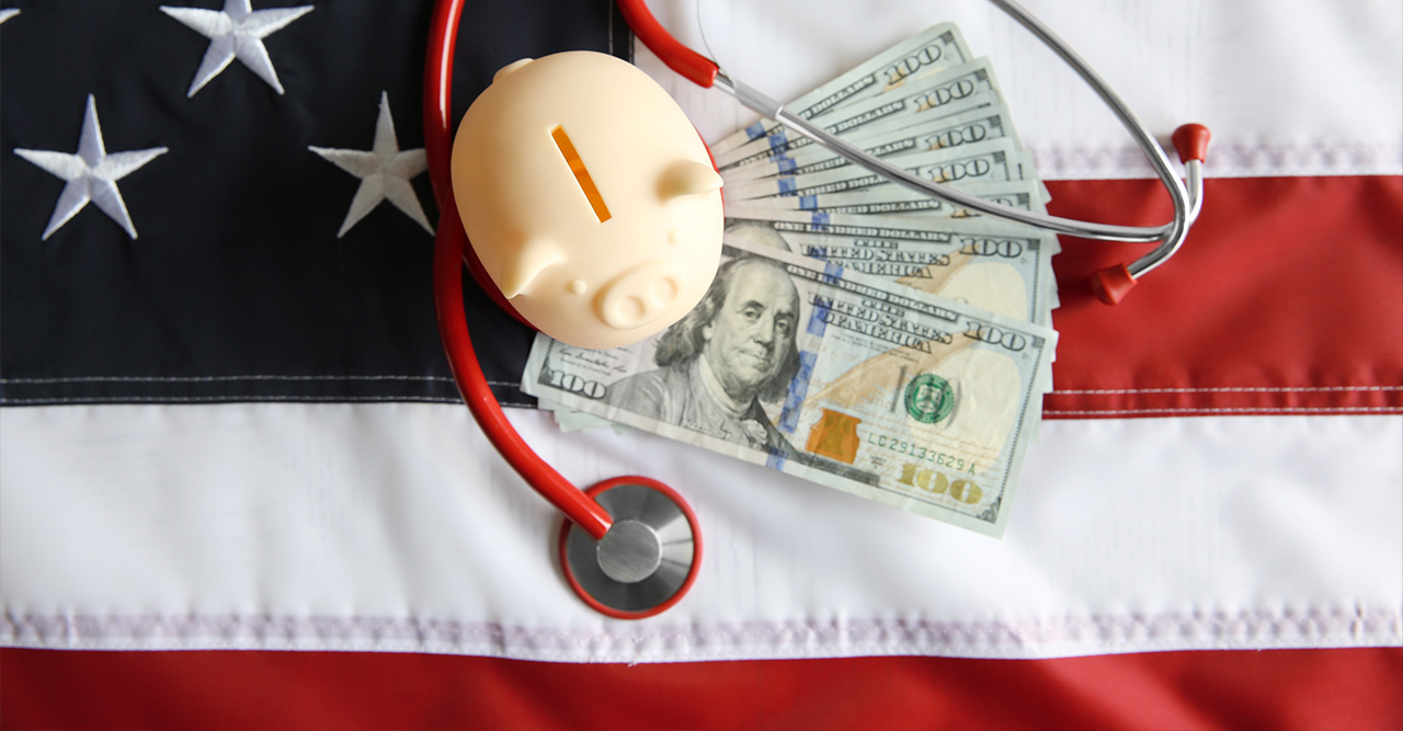 A piggy bank, US cash and a stethoscope on an american flag - Medicaid Planning Lawyer concept image