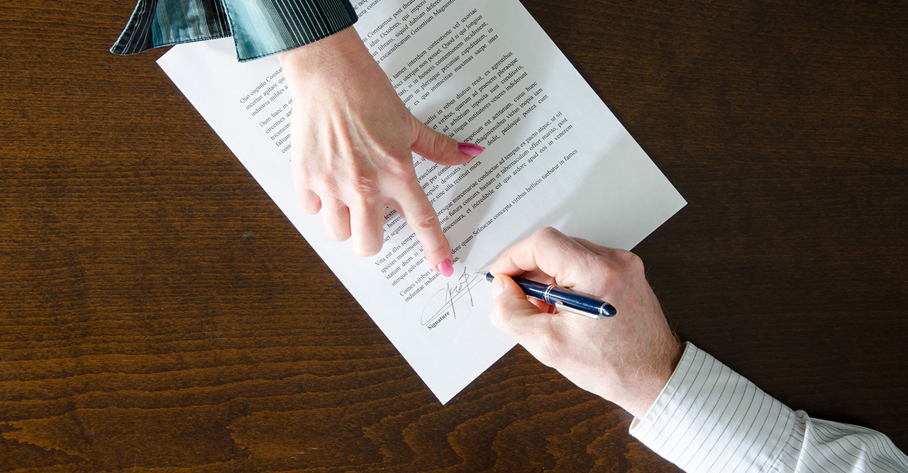 A lawyer and a client signing a powers of attorney order -