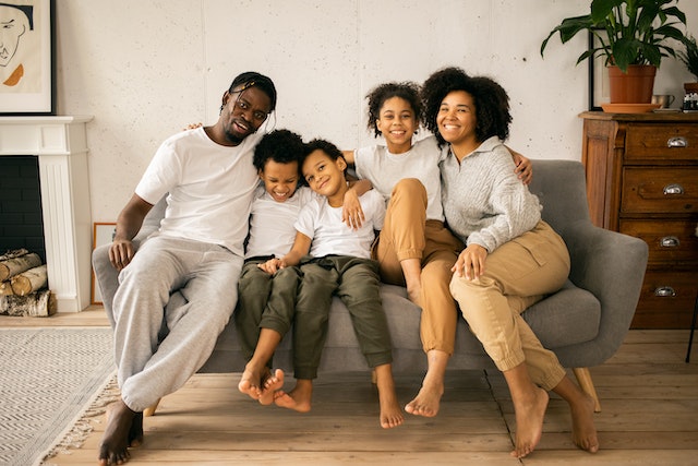 family sitting on the couch smiling