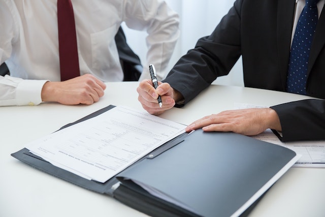 people signing documents