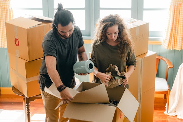 man and woman packing boxes