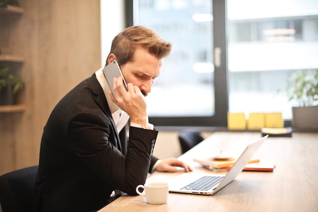 man on phone looking at documents