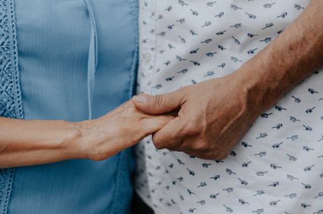 older couple holding hands