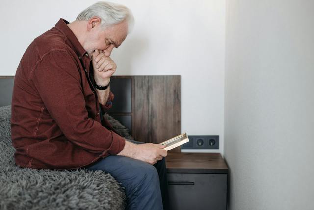 man looking at picture grieving