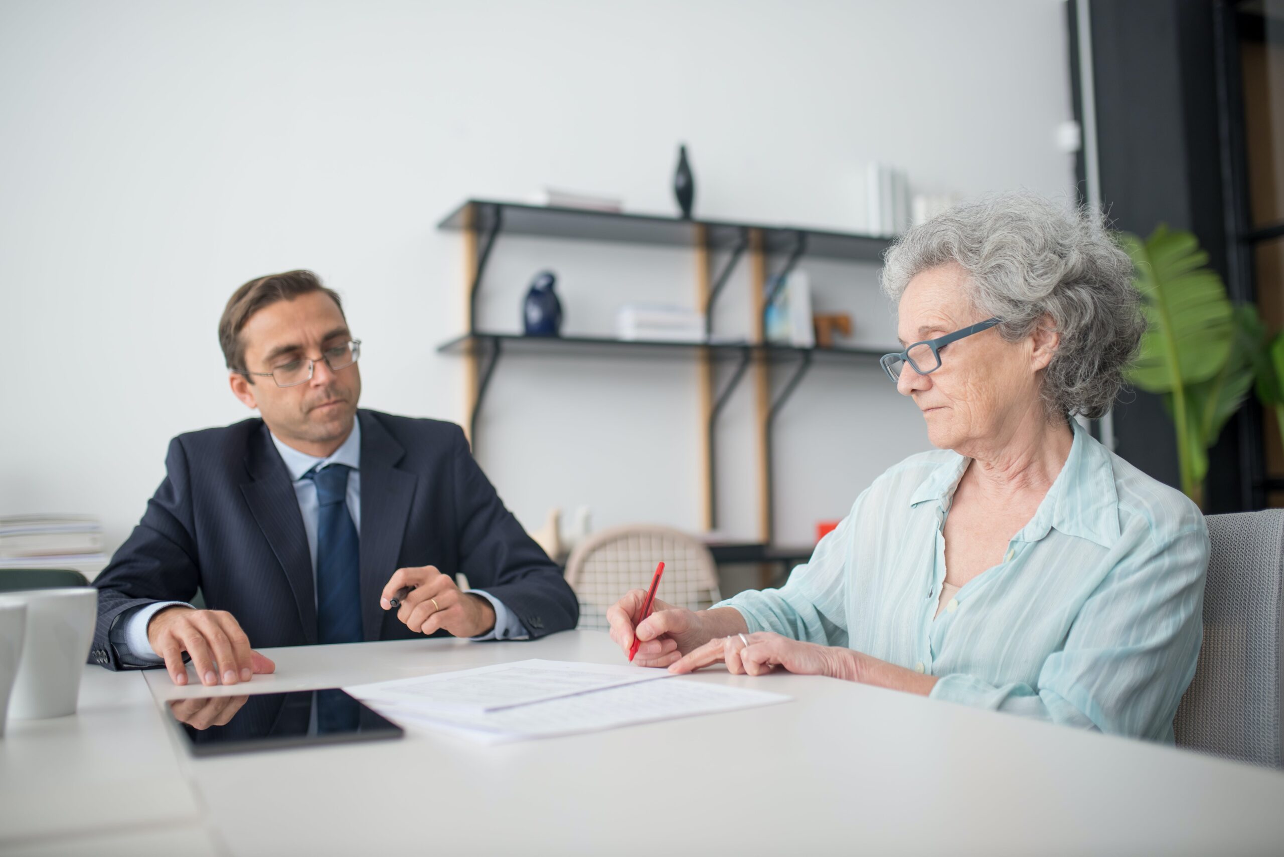 woman and man signing legal documents