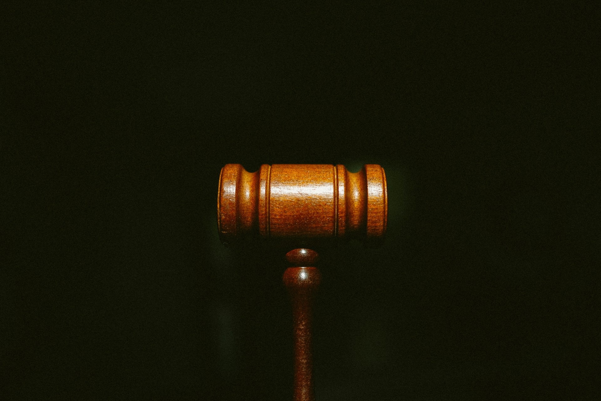 brown gavel against black background